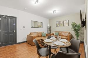 a living room with a table and a couch at Clayton Apartments in Newcastle upon Tyne +290 photos