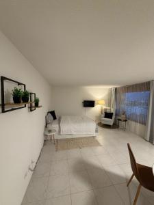 a bedroom with a bed and a living room at Studio Lakeview in Ennetbürgen