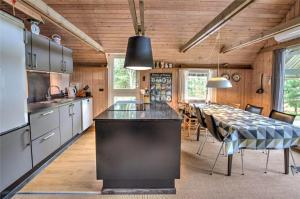a kitchen with a large black island in a room at 0314-Romo-Kliren-3 in Høm
