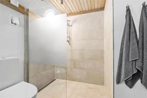 a bathroom with a glass shower with a toilet at 0314-Romo-Kliren-3 in Høm +21 photos