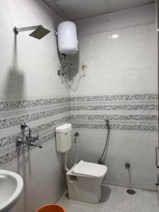 a bathroom with a toilet and a sink at Hotel Shivaay Inn in Kānpur +34 photos