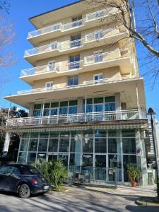 a building with a car parked in front of it at Miramare Resort in Rimini