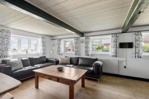 a living room with a couch and a table at 2001-Romo-Juvrevej-80 in Høm