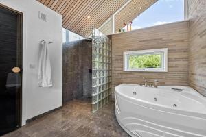 a large bathroom with a tub and a window at 0399-Romo-Strandskaden-22 in Høm +26 photos