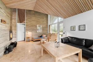 a living room with a couch and a table at 0399-Romo-Strandskaden-22 in Høm