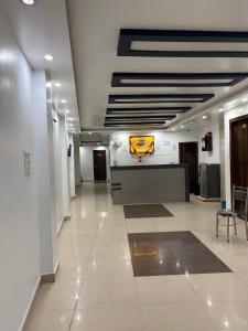 a hallway of a building with a lobby with a table at Hotel Shivaay Inn in Kānpur