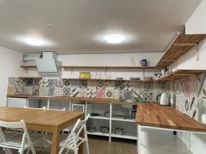 a kitchen with a wooden table and a dining room at At the Burkulis' in Ljubljana