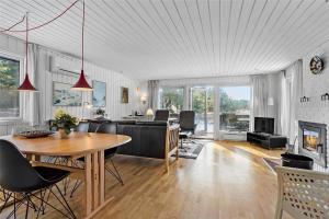 a living room with a table and a couch at 0028-Romo-Blabaervej-28 in Høm