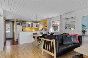 a living room and kitchen with a couch and a table at 0028-Romo-Blabaervej-28 in Høm
