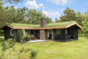 a house with a green roof with a grass covered at 0028-Romo-Blabaervej-28 in Høm