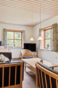 a living room with a table and chairs at 0462-Romo-Romersvej-9-Ap-2 in Høm