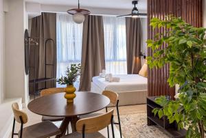a hotel room with a bed and a table and chairs at Studios Mugakoa By Sahats in Portugalete