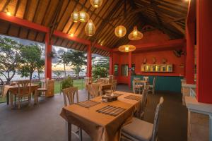 a dining room with tables and chairs and lights at Villa Sky Dancer - Bali in Amed