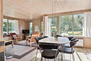 a living room with a table and chairs at 0215-Romo-Vestergardsvej-8 in Høm