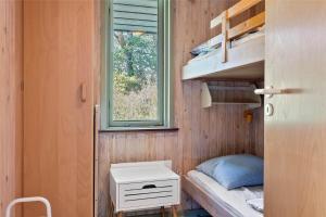 a tiny house with a bed and a window at 0215-Romo-Vestergardsvej-8 in Høm