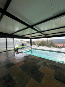 a large swimming pool with a large ceiling at Casa Pepe in Ourense