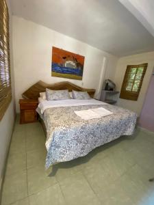 a bedroom with a large bed in a room at Jardín del Mango Nu in Zipolite +10 photos