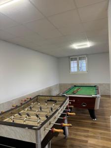 a room with a ping pong table and a pool at Casa Pepe in Ourense