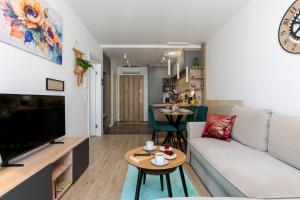 a living room with a couch and a table at Apartament Sun&City in Bielsko-Biała