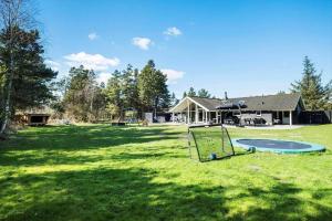 a large yard with a trampoline in front of a house at 0120-Romo-Smafolksvej-61 in Høm