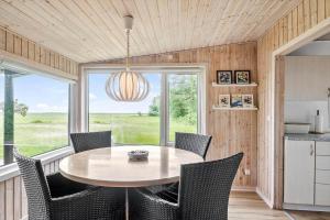 a kitchen and dining room with a table and chairs at 0264-Romo-Lyngvejen-37 in Høm