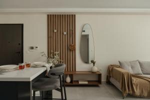 a bedroom with a bed and a table and a mirror at Estia Urban Stay in Ioannina