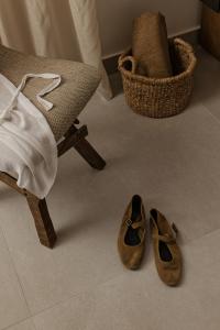a pair of shoes on the floor next to a chair at Estia Urban Stay in Ioannina