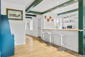 a kitchen with green and white walls and stools at 2804-Romo-Bornholmervej-4 in Høm +19 photos