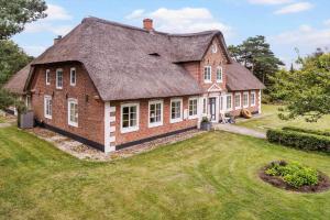 a large red brick house with a large yard at 2804-Romo-Bornholmervej-4 in Høm