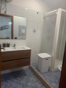 a bathroom with a sink and a toilet and a shower at Casa indipendente favignana in Favignana