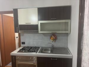 a small kitchen with a stove and a sink at Casa indipendente favignana in Favignana