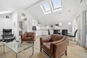 a living room with two chairs and a glass table at 0281-Romo-Vestergade-3-Ap-13 in Høm