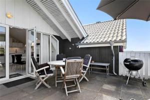 a patio with a table and chairs and a grill at 0281-Romo-Vestergade-3-Ap-13 in Høm +22 photos