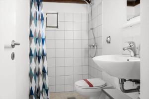 a bathroom with a toilet and a sink at 0418-Romo-Sonderstrandvej-19 in Høm +22 photos
