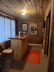 a kitchen with a counter and a red rug at Aurora House in Ironwood