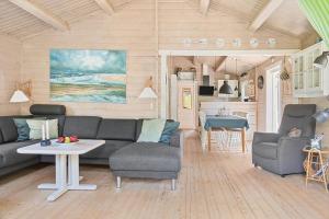 a living room with a couch and a table at 0311-Romo-Strandskaden-10 in Høm
