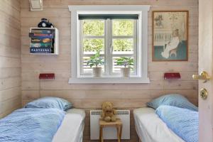 a room with two beds and a teddy bear on a table at 0311-Romo-Strandskaden-10 in Høm