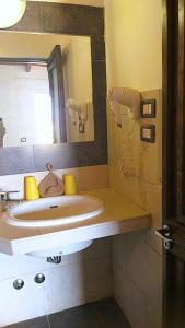 a bathroom with a sink and a mirror at Pensao Porta do Vento in Santa Maria +37 photos