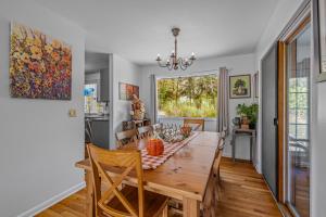 a kitchen and dining room with a table and chairs at Serendipity -- Hot Tub - Pet Friendly - Fire Pit - Grill - Porch - Deck - Wifi - Pool Access - Games in Berkeley Springs