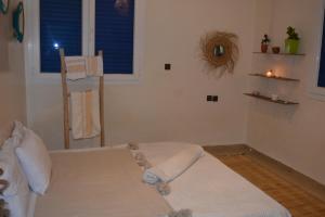 a bedroom with a bed with a teddy bear on it at west wave surf house in Tamraght Ouzdar