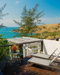 a patio with a table and chairs and the ocean at Greco Hotel in Búzios +92 photos