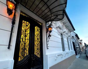 a door of a building with yellow glass at Chateau D'Amour Luxury Boutique in Bucharest
