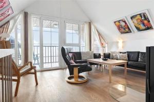 a living room with a couch and a table at 0230-Romo-Havnebyvej-61-E in Høm