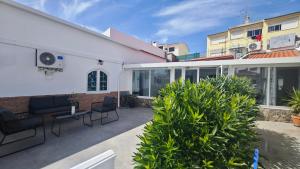 a patio of a house with chairs and plants at Cascais Garden House in Cascais