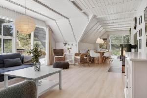 a living room with a couch and a table at 2600-Romo-Vestergardsvej-18 in Høm +25 photos