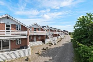 a row of houses on a dirt road at 0389-Romo-Vestergade-3-Ap-77 in Høm