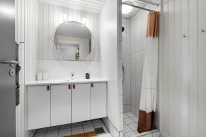 a white bathroom with a sink and a mirror at 0295-Romo-Vestergade-3-68-E in Høm +17 photos