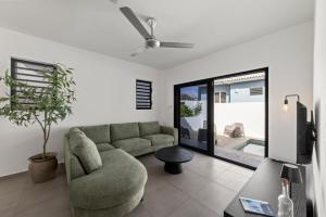 a living room with a couch and a tv at Tropilena Resort in Willemstad