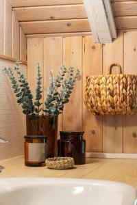 a bathroom with a vase with a plant and a basket at 0153-Romo-Julianehab-5 in Høm