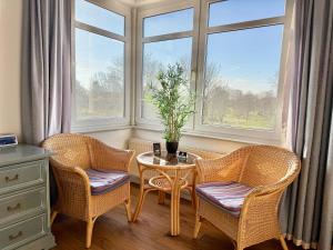 a room with two chairs and a table and a window at Gästehaus Weserblick am Weser-Sandstrand in Berne